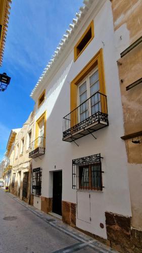 a white building with windows and balconies on a street at El 34 in Lorca