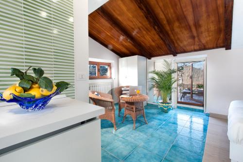 Una cocina y una sala de estar con mesa y sillas. en Maison Villa Angela, en SantʼAgata sui Due Golfi