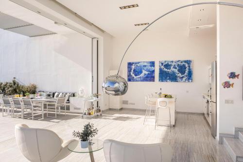 a living room with white furniture and a large window at Protaras Elaia Luxury Seafront Villa in Protaras