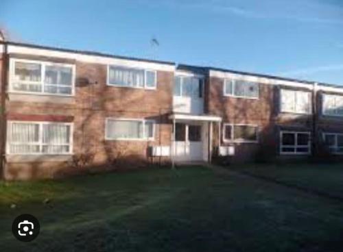 a large brick building with a yard in front of it at Above us only sky in Kirkby