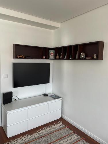 a living room with a flat screen tv on a wall at Apartament Praceta Vila do Conde in Vila do Conde