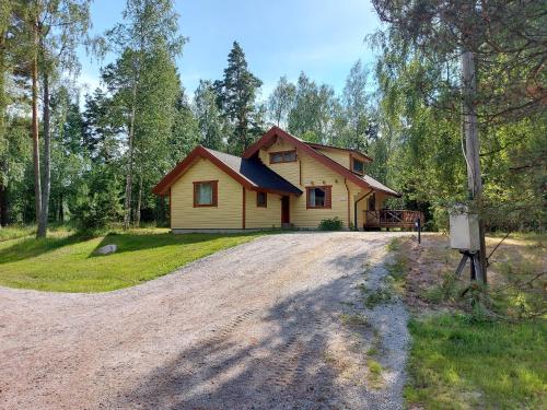 a house on a dirt road in the woods at Fishing and holiday village Merikoivula in Uusikaupunki