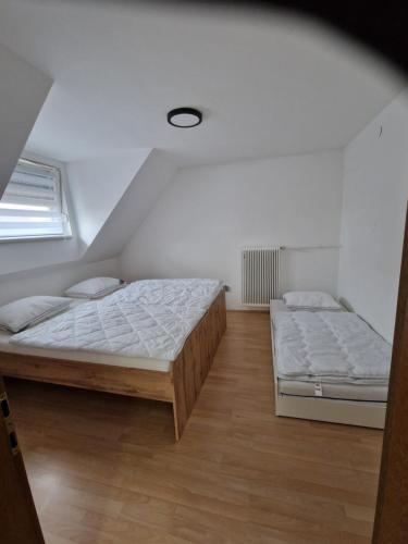 a bedroom with two beds and a window at Apartment LARA in Sankt Peter am Bichl