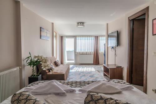 a hotel room with a bed and a living room at City Hall Apart Hotel Sultanahmet in Istanbul