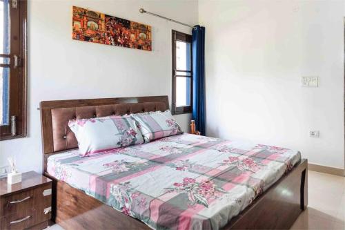 a bedroom with a bed with a quilt on it at 3BR Apartment by B-Town stays in Dehradun