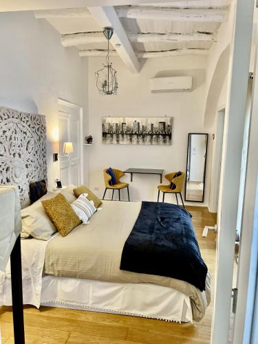 a bedroom with a large bed and a table at Casa Pepe Via Fuoro in Sorrento