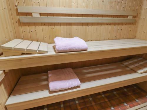 a wooden sauna with two towels on a shelf at Bride Cross Granary in Otley