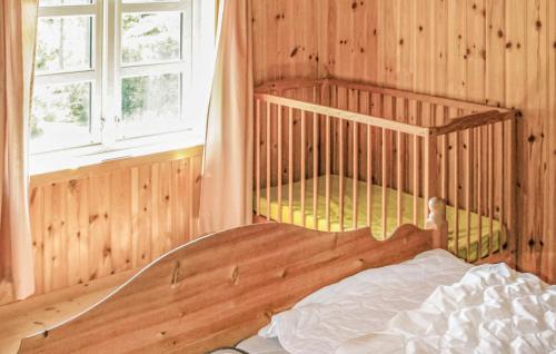 a bedroom with two bunk beds and a window at Lovely Home In Farsund With Wi-fi in Farsund