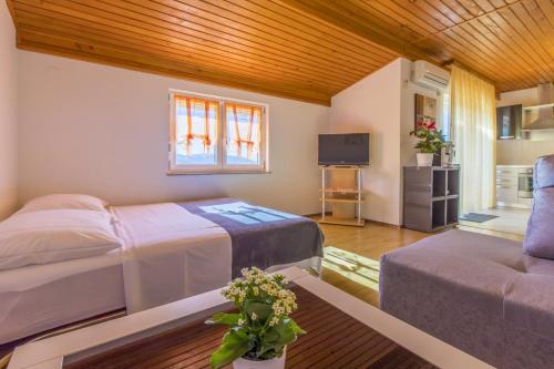 a bedroom with a bed and a couch at RASTOVCAN P in Povile