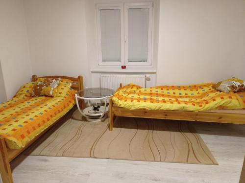 dos camas sentadas una al lado de la otra en una habitación en chalupa, en Žďár nad Sázavou