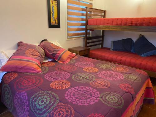 a bedroom with a bed and a bunk bed at Cabaña Pelluhue in Pelluhue