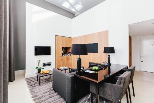 a living room with a dining room table and chairs at The Dylan Amsterdam - The Leading Hotels of the World in Amsterdam