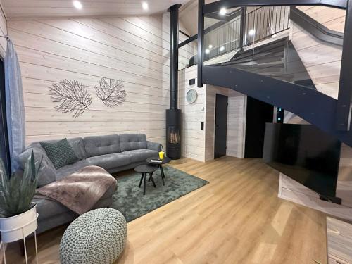 a living room with a couch and a staircase at Yläkasi in Kittilä