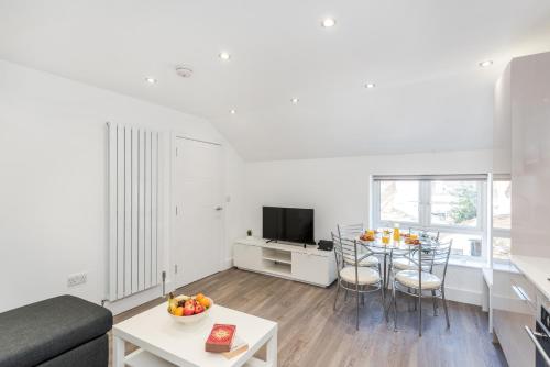 a living room with a couch and a table at Livestay Stunning 2 bed apartments in Stratford in London