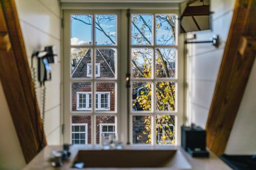a bathroom window with a view of a building at The Dylan Amsterdam - The Leading Hotels of the World in Amsterdam