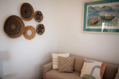 a living room with a couch and plates on the wall at Ocean Vista Retreat in Skála
