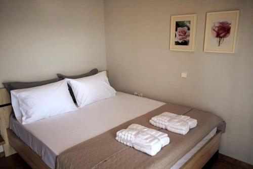 a bedroom with a bed with two towels on it at Ocean Vista Retreat in Skála