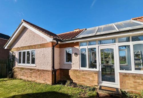an extension to a house with a solar roof at Firs End - Close to Norfolk Broads and Coast - Crabpot Cottages Sheringham in North Walsham