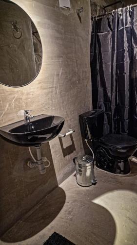 a bathroom with a sink and a toilet at Urban Hostal San Gil- Piscina Restaurante Bar in San Gil