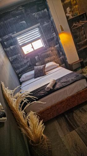 a bed in a room with a window at Urban Hostal San Gil- Piscina Restaurante Bar in San Gil