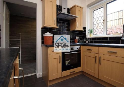 a kitchen with a sign that says the spa properties at Modern 4BR Home-7 Guests-Business-Families-Netflix-Free Parking & WiFi in Pontnewynydd