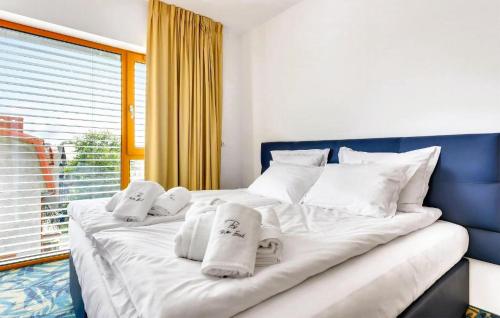 a large white bed with towels on top of it at 2 Bedroom Gorgeous Apartment In Hel in Hel