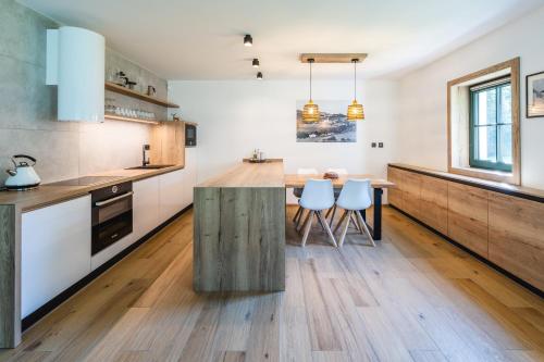 a kitchen with a wooden counter top and a table at Hygge Apartments in Rožmberk nad Vltavou