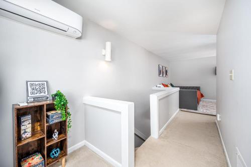 an attic hallway with white walls and a white door at Retro Loft steps from Duke in Durham