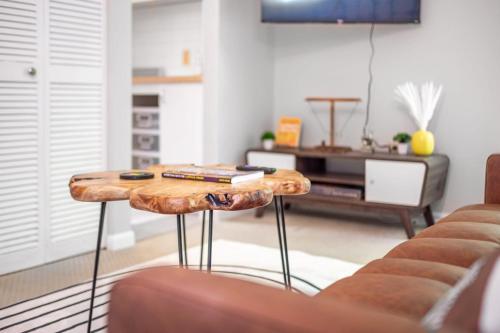 a living room with a table and a couch at Retro Loft steps from Duke in Durham