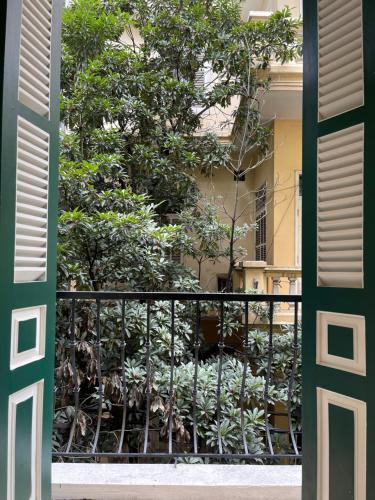 an open door to a balcony with trees at Dodo home XD in Hanoi