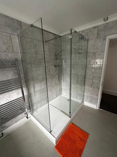a shower with a glass enclosure in a bathroom at Town Centre Studio Flat in Merthyr Tydfil
