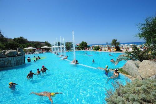 a group of people in a pool at a water park at Solemare Club Village in Capo Vaticano