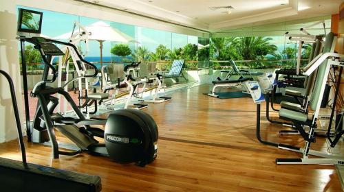a gym with treadmills and elliptical machines at Royal Beach eilat in Eilat