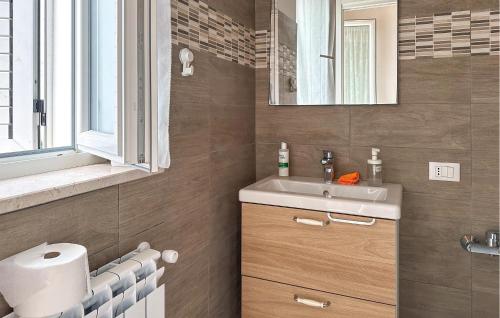 a bathroom with a sink and a mirror at 4 Bedroom Pet Friendly Home In Cugnoli in Cugnoli