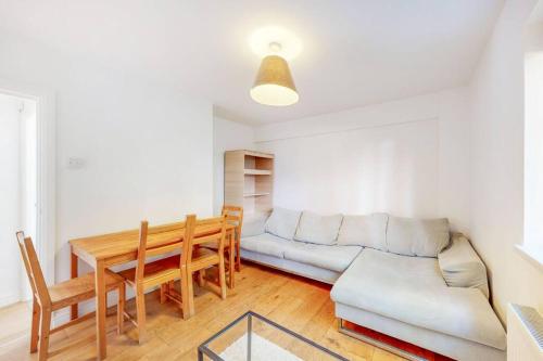 a living room with a couch and a table at Cozy 3 bedroom apartment in Brixton in London