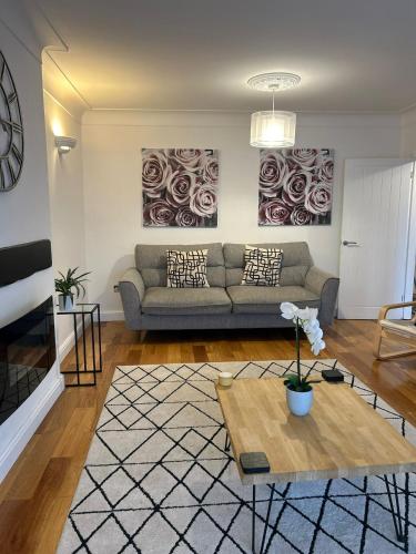 a living room with a couch and a table at BROOK HOUSE 4a in Llangollen