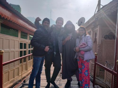 a group of women posing for a picture on a bridge at Pasadona Floating Houseboat in Srinagar