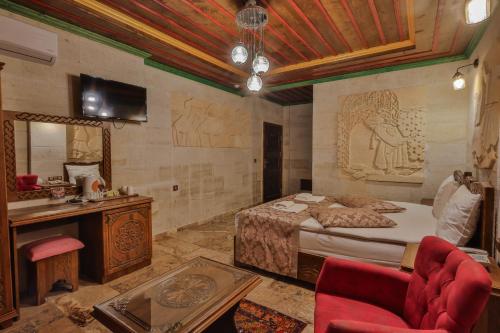 a bedroom with a bed and a vanity and a mirror at Feel Cappadocia Stone House in Göreme