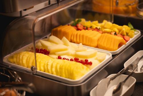 a tray of different types of cheese and fruit at Palace Catania | UNA Esperienze in Catania