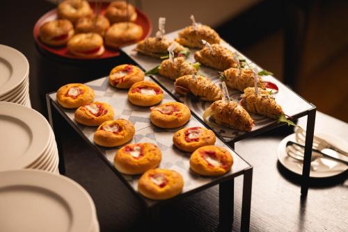 a bunch of food on trays on a table at Palace Catania | UNA Esperienze in Catania