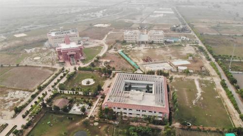 an aerial view of a city with buildings at ISKCON'S GITANAGARI RETREAT CENTER VRINDAVAN in Jait