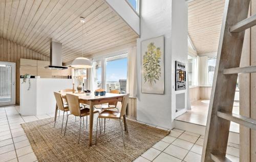 a kitchen and dining room with a table and chairs at Holiday Home Ålevej Ebeltoft I in Ebeltoft