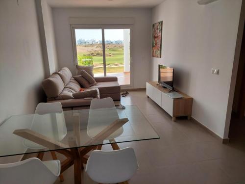 a living room with a glass table and a couch at Golf Las Terrazas de La Torre LRVDM House in Roldán