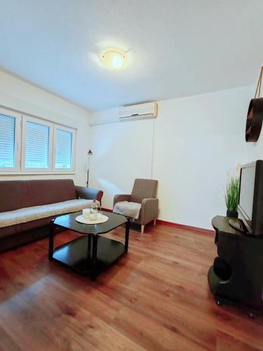 a living room with a couch and a coffee table at Apartment Libar with Terrace and private Parking in Mostar