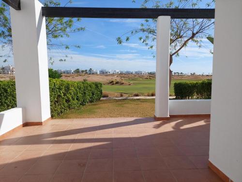 an open porch with a view of a golf course at Golf Las Terrazas de La Torre LRVDM House in Roldán