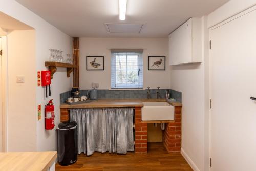 a kitchen with a sink and a counter at Skylark Cottage at Seven Sisters in West Dean