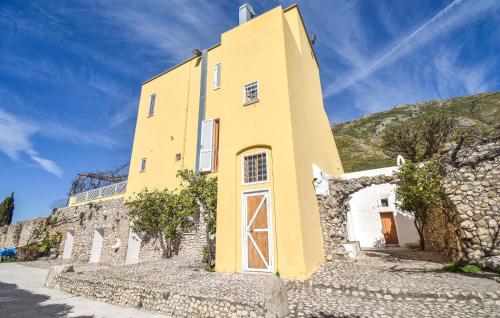 a yellow building on the side of a hill at 3 Bedroom Stunning Home In Mondragone in Mondragone