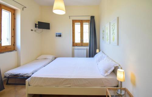 a bedroom with two beds and a television in it at 3 Bedroom Stunning Home In Mondragone in Mondragone