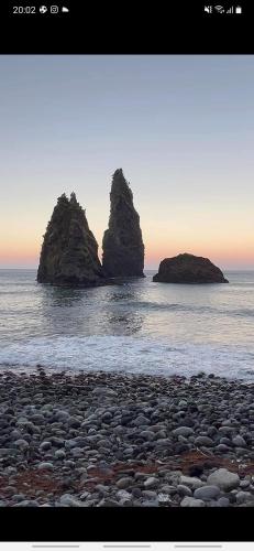 two large rocks in the water on a beach at Casa vicente in Santa Cruz das Flores