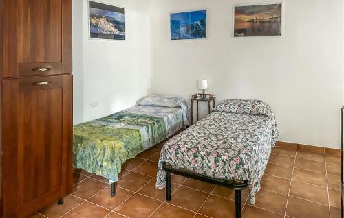 a bedroom with two twin beds and a cabinet at 4 Bedroom Pet Friendly Home In Cugnoli in Cugnoli